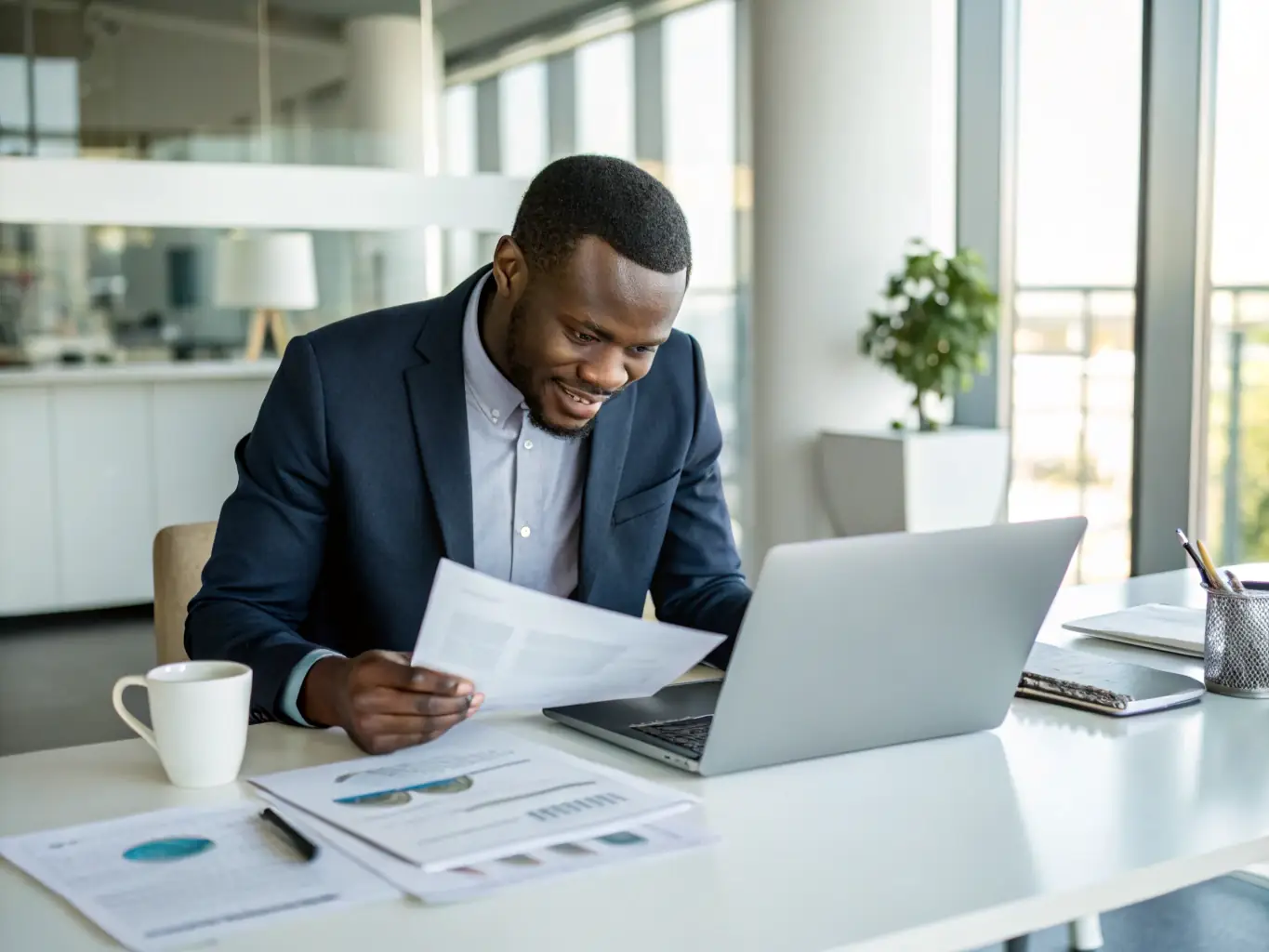 An image of a business owner reviewing financial documents in a modern office setting. This image represents Business Loans offered by Vangel Capital Group.